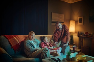 Family watching television in the living room