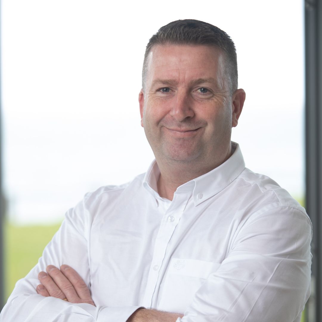 head shot of man wearing white shirt